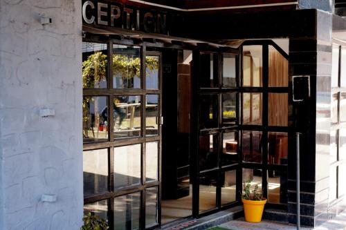 an open door to a building with a window at Vacay inn Hotel in Nainital