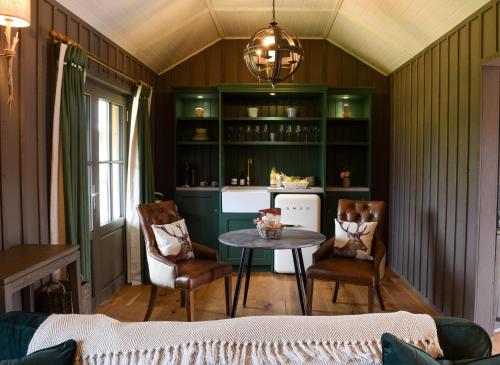 a living room with a table and chairs at Retreat East in Ipswich