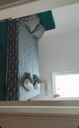 a window in a room with a curtain and a tie at Apartman Comfort Beograd in Belgrade