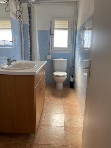 a bathroom with a toilet and a sink and a window at Exclusivo Apartamento ALZIRA in Alzira