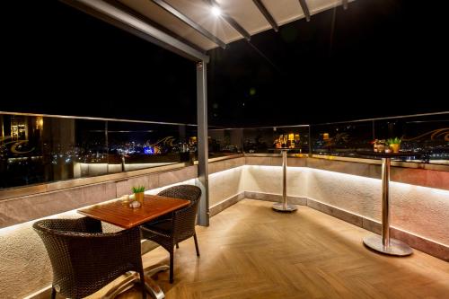a table and chairs on a balcony with a view at Marigold Thermal & Spa Hotel Bursa in Bursa