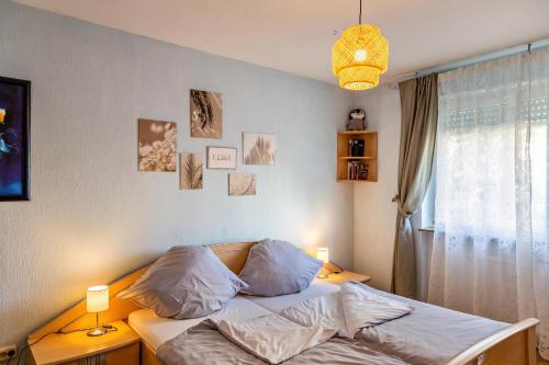 a bedroom with a bed with pillows and a window at Haus Zum Rochusberg 1 in Bingen am Rhein