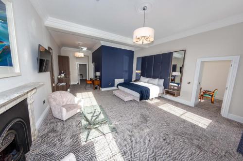 a hotel room with a bed and a fireplace at Commodore Hotel in Cobh