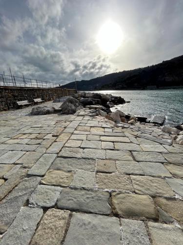 a stone walkway next to a body of water at Gli scogli a due passi in Portovenere