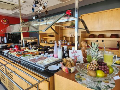 a buffet of food on a counter in a kitchen at ibis Montes Claros Shopping in Montes Claros