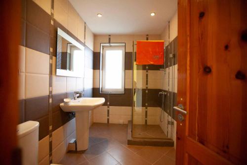 a bathroom with a sink and a shower at Villa Musica in Balchik