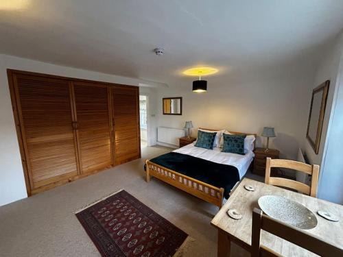a bedroom with a bed and a table in it at Grouse in Lyddington