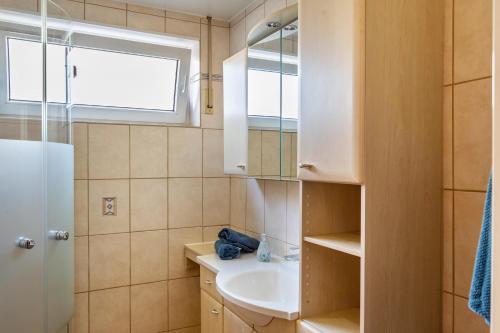 a bathroom with a sink and a window and a mirror at Haus Zum Rochusberg 2 in Bingen am Rhein