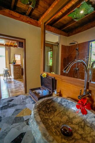 a bathroom with a large stone sink in a room at KTS Balinese Villas in Canggu