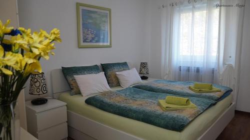 a bedroom with a bed with two towels on it at Apartments Marja in Njivice