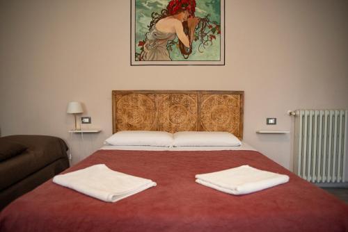 a bedroom with a bed with two towels on it at Villa Aldo e Lalla in Rozzano