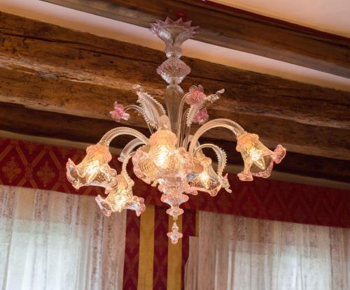 a chandelier hanging from a ceiling in a room at Messner Palace in Venice