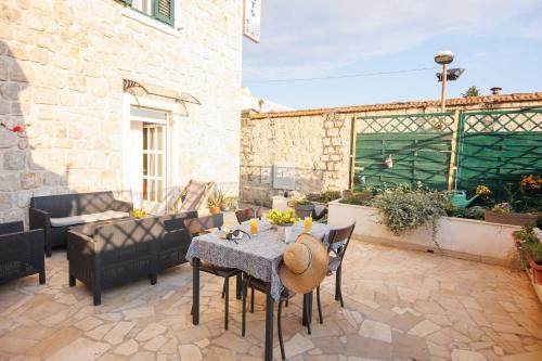 a patio with a table and chairs and a couch at Apartments Gabrieri in Dubrovnik