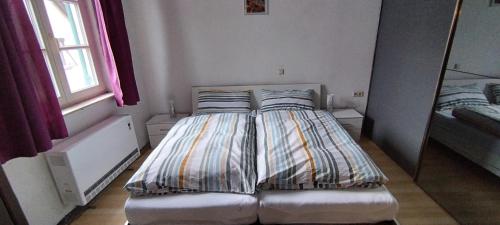 a bed in a small room with a mirror at Wohnung Engelgasse in Biberach an der Riß