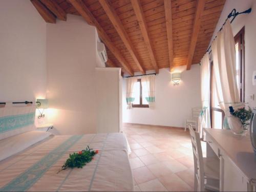 a large room with a table and a kitchen with windows at Apartment in Vignola Mare near Sandy Beach in Vignola Mare