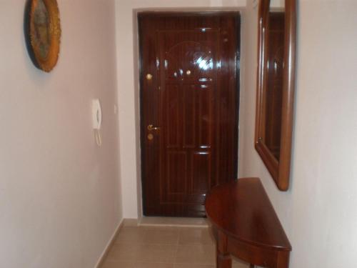 a wooden door in a room with a wooden table at Jana apartments 2 in Tivat