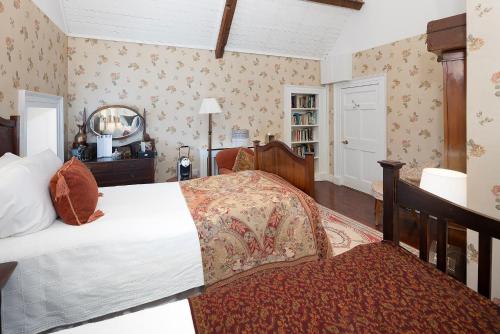 a bedroom with a large bed and a mirror at Barnabrow Country House in Killinagh