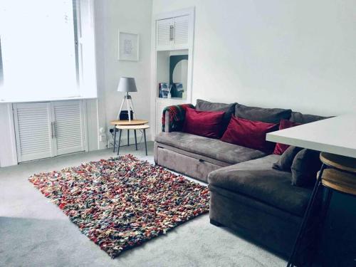 a living room with a couch and a rug at Galashiels, Scottish Borders, One Double Bed in Galashiels
