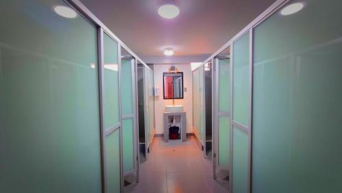 a hallway in a building with glass walls at Magic Packer Hostel in Cusco