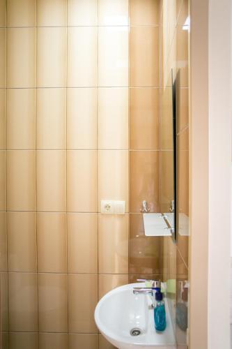 a bathroom with a sink and a mirror at Tulipan Hotel Aquapark in Vyshkove
