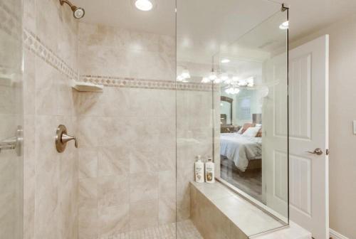 a bathroom with a walk in shower and a mirror at Bay View in San Diego
