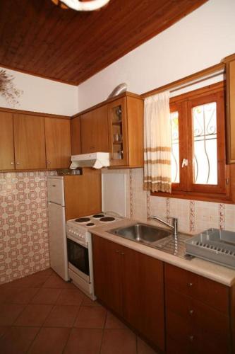 a kitchen with a sink and a stove top oven at Apartment Alex 3, Barbati in Barbati