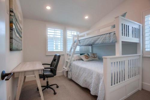 a bedroom with a bed and a desk and a bunk bed at Bayside Cove 2 in San Diego