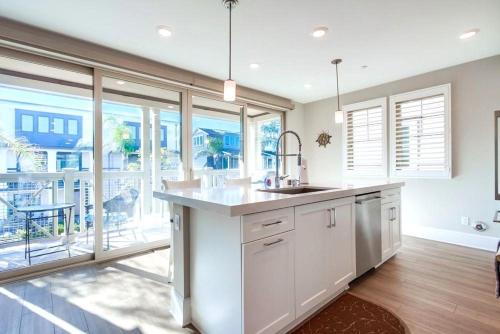 a kitchen with a sink and a large window at Bayside Cove 4 in San Diego