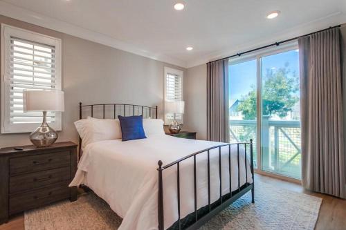a bedroom with a bed and a large window at Bayside Cove 4 in San Diego