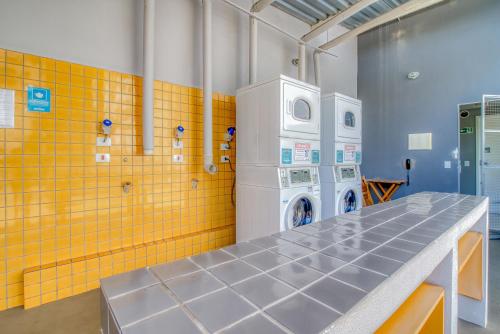 a laundry room with a washer and a washing machine at 360 Santa Ifigênia in Sao Paulo