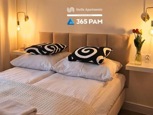 two pillows on a bed in a bedroom at Apartament Dobra Aura - 365PAM in Ustronie Morskie