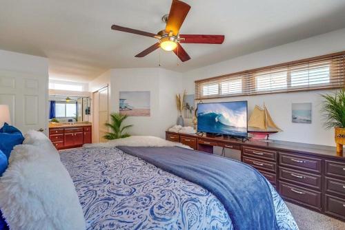 a bedroom with a bed and a ceiling fan at Beach Haven 2 in San Diego