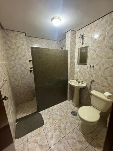 a bathroom with a toilet and a sink at Hotel Garnier in Campos do Jordão