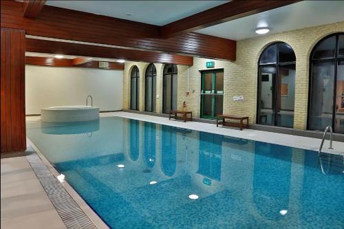 a large swimming pool with a tub in a building at The University of Buckingham - Mount Pleasant in Buckinghamshire