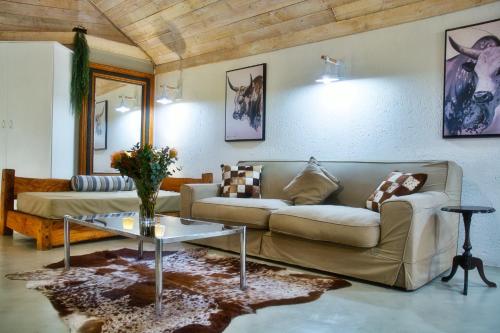 a living room with a couch and a table at Glenda's Guest Suites in Midrand