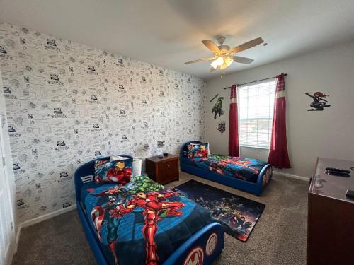 a bedroom with a spiderman themed bed and couch at Windsor Hills Resort- 402F in Orlando