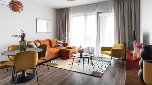 a living room with a couch and a table at Lion Apartments - SCALA City Center Apartments&Parking IB in Gdańsk