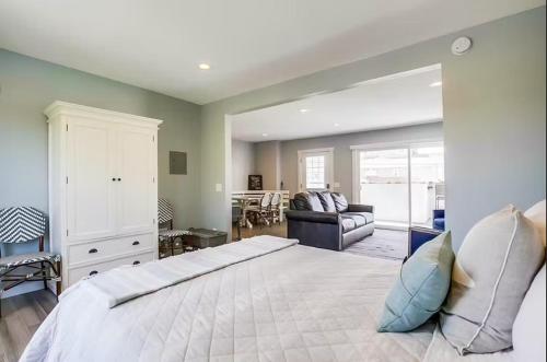 a bedroom with a large bed and a living room at Beachy Keen 1 in San Diego
