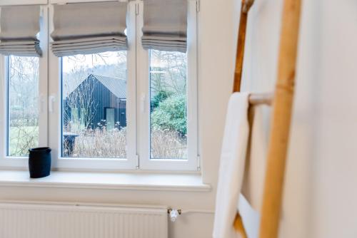 a window with a view of a barn at Aarskogs Boutique Hotel in Glücksburg