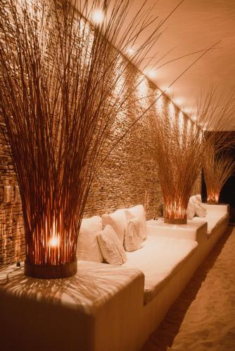 a row of beds in a room with plants at Villa Praia - La Villa Group in Jericoacoara