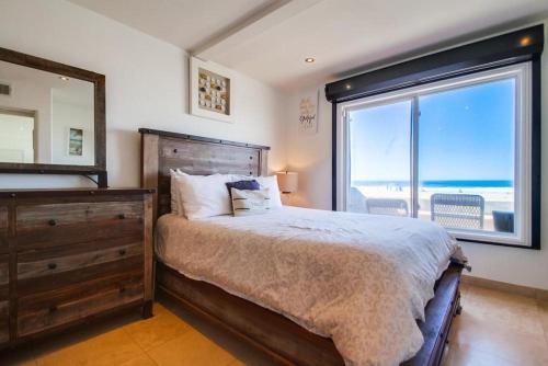 a bedroom with a large bed and a large window at Belmont Shores in San Diego