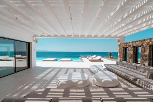 a living room with a view of the ocean at Splendid Mykonos Waterfront Villa in Mikonos