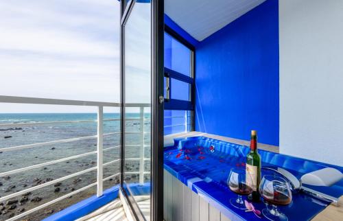 a blue room with a view of the ocean at On The Sea Pension in Jeju