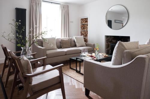 a living room with a couch and a table at Ballintaggart Farmhouse in Logierait