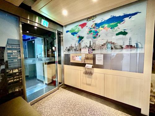 a store front with a large mural of a world at Evergreen motel in Geoje 