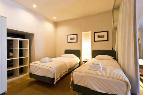 a bedroom with two beds in a room at RVA - Gustave Eiffel Apartments in Porto