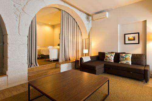a living room with a couch and a table at RVA - Gustave Eiffel Apartments in Porto