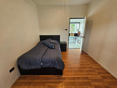 a bedroom with a bed with a blue pillow on it at Castle Villa Phuket in Kamala Beach