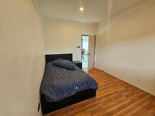 a bedroom with a bed with a blue pillow on it at Castle Villa Phuket in Kamala Beach