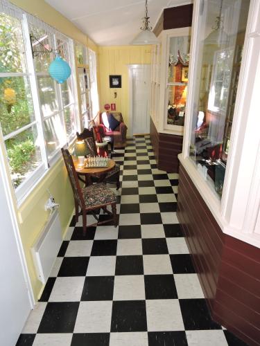 a living room with a checkered floor at KUBBA ROONGA GUESTHOUSE - Boutique Luxury Spa Retreat & Gardens - Blue Mountains in Blackheath
